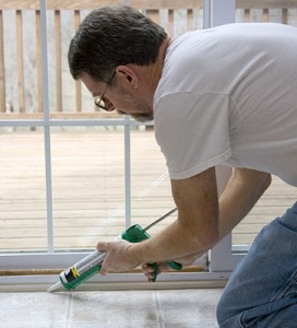 Applying caulk to a door frame